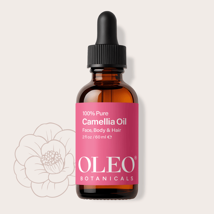 Bottle of Oleo Botanicals Camellia Oil with a pink label on a light gray background